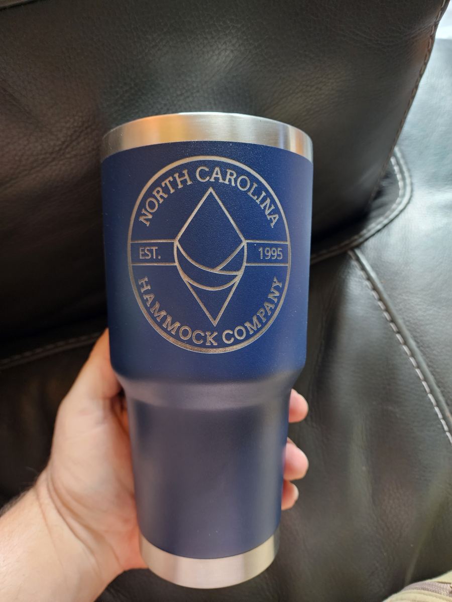 Blue tumbler with a custom engraved emblem
